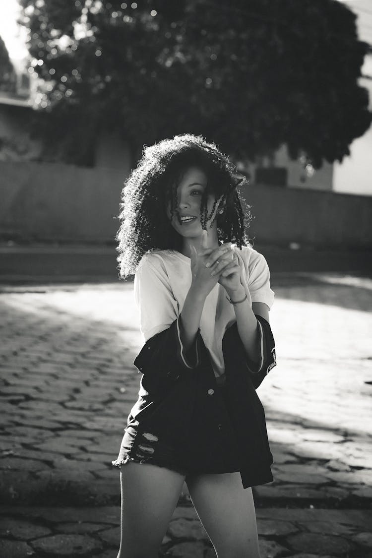 Curly Haired Woman Posing On Street