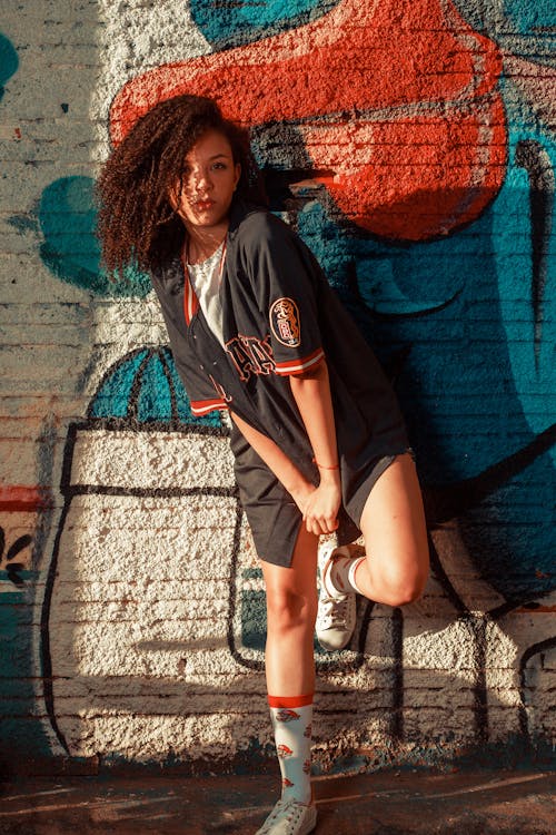 Woman Wearing a Jersey Leaning on Wall