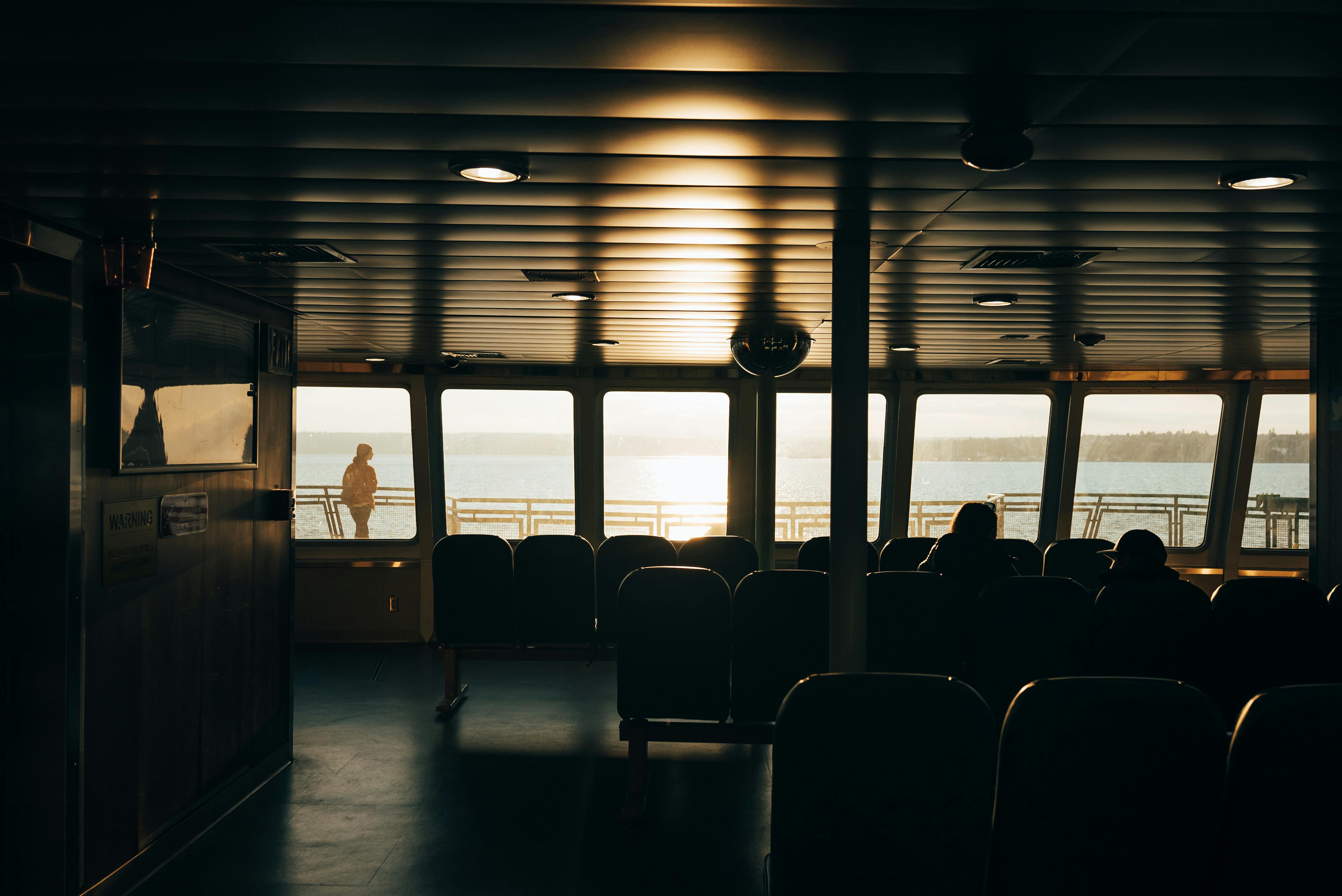 silhouette of people sitting on chair inside train