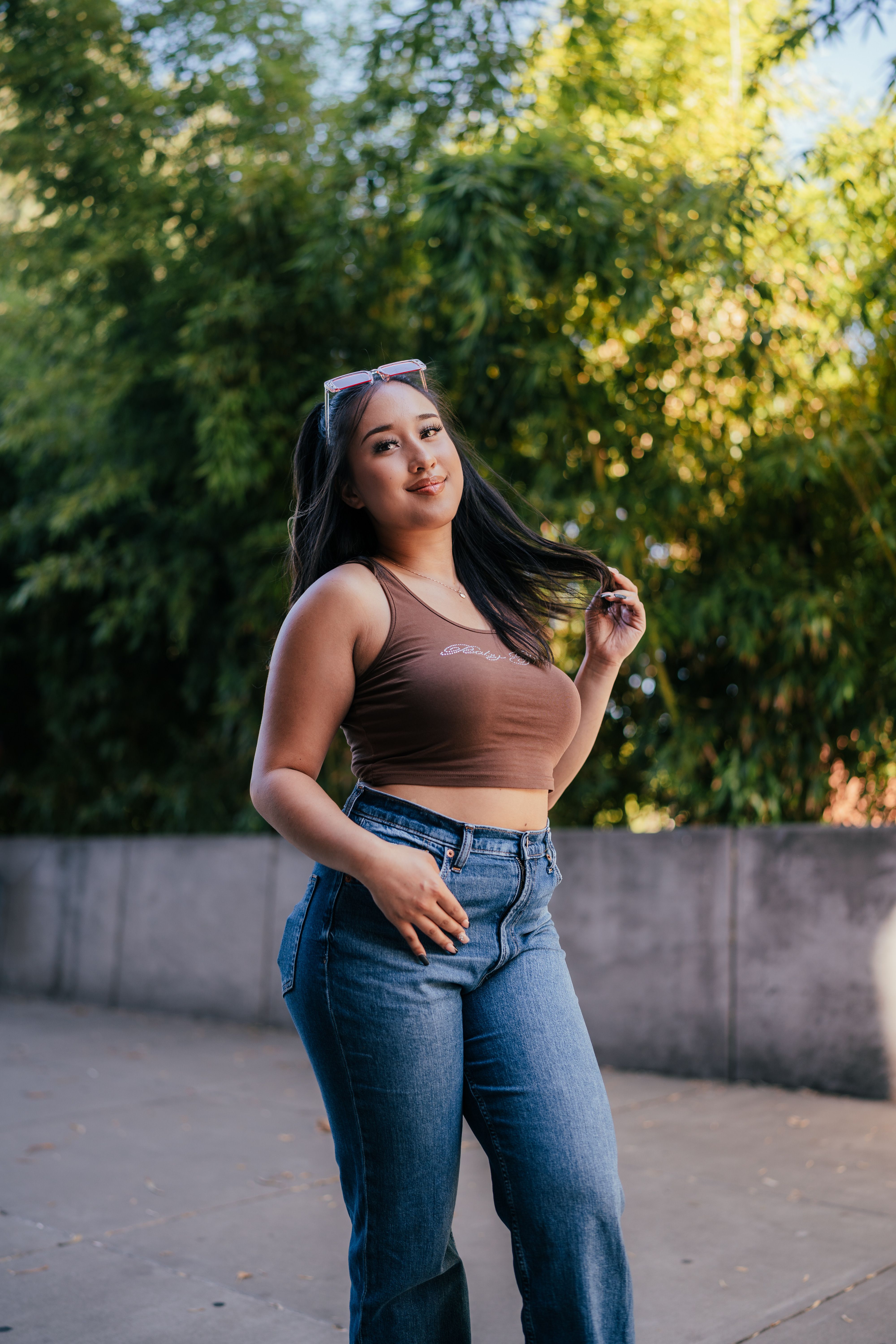 A Woman Wearing Brown Crop Top and Denim Jeans · Free Stock Photo
