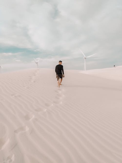 Back View of a Man Walking on the Dunes