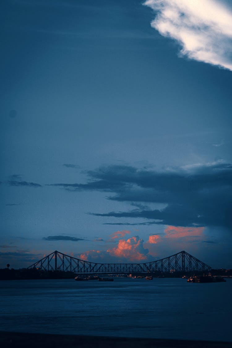 Bridge Over River At Sunset