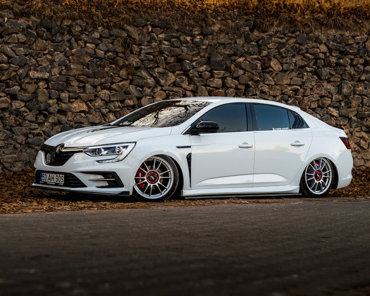 Stance Car Parked By Stone Wall