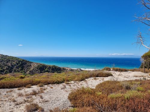 Free Stunning coastal landscape of Rhodes, Greece with clear blue skies and lush greenery. Stock Photo