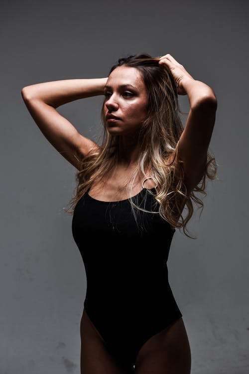 Young Woman in a Bodysuit Posing in Studio 