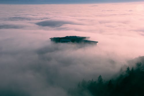 View of a Top of a Building above Clouds 