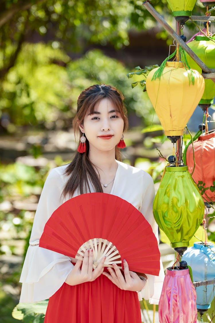 Beautiful Woman Holding Red Fan