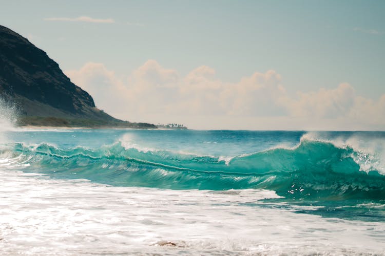 A Big Waves Crashing Under The Cloudy Sky