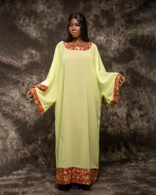 Free Woman wearing a flowing traditional gown with intricate patterns, capturing elegance and culture. Stock Photo