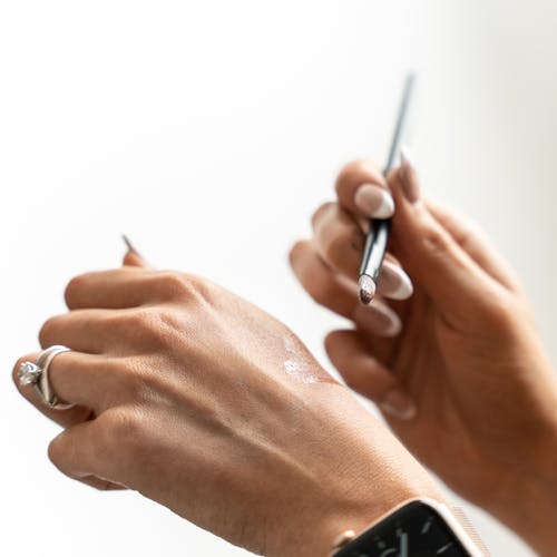 Close-up of Woman Holding a Small Makeup Brush 