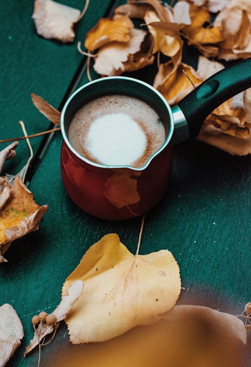 Cup of Coffee on Green Surface