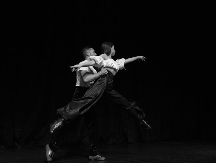 Grayscale Photo Of A Man And Woman Dancing 