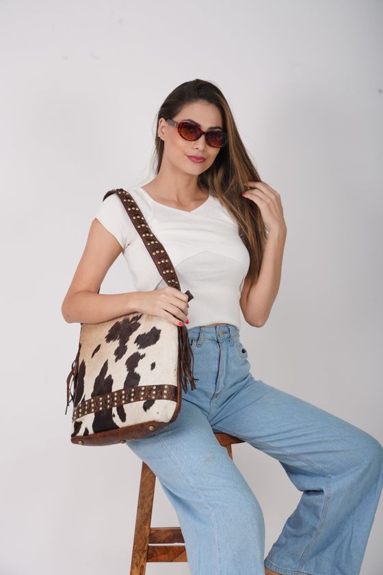Woman in denim modelling a patterned shoulder bag, photo by addy bronzzz on Pexels