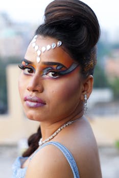Artistic portrait of a woman in Patna with bold makeup and face jewels, showcasing glamour and creativity.