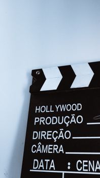 Close-up vertical shot of a clapperboard with text, ideal for film and media themes.