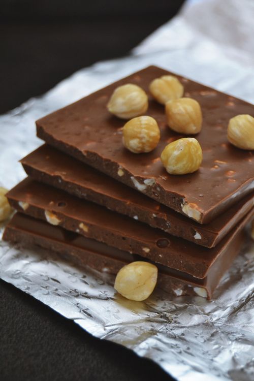 Free Close-up of chocolate bars with hazelnuts on foil, perfect for sweet cravings. Stock Photo