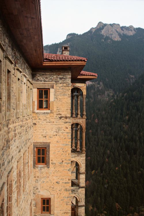 Free View of Sumela Monastery's facade with surrounding lush mountains in Turkey. Stock Photo