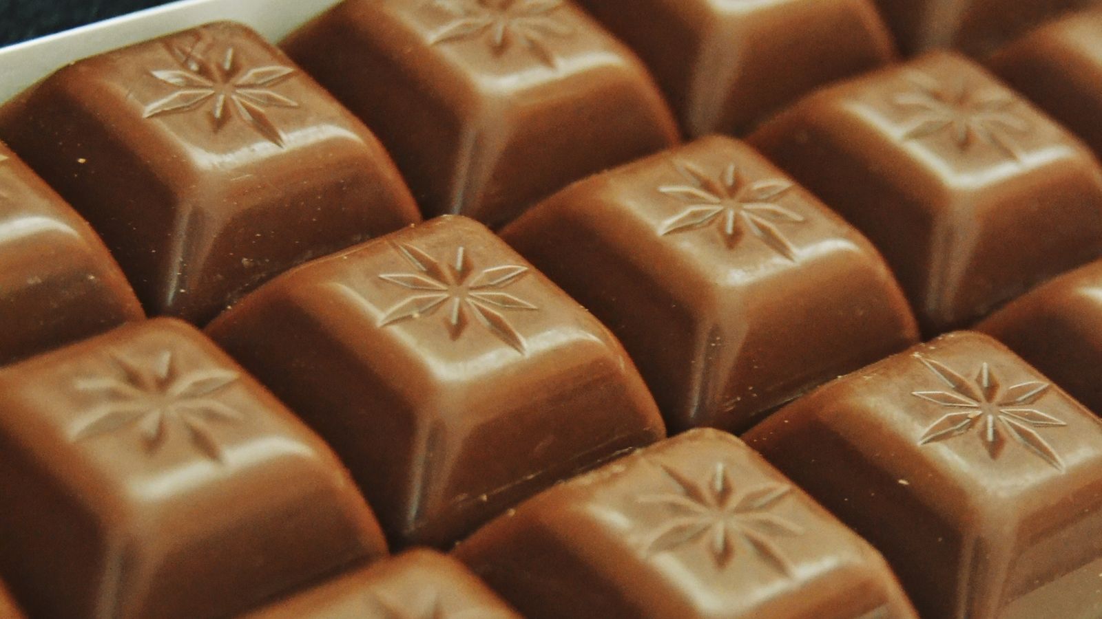 Close-up of milk chocolate squares arranged in a tray — photo by Duygu Kamar on Pexels Close-up of milk chocolate squares arranged in a tray