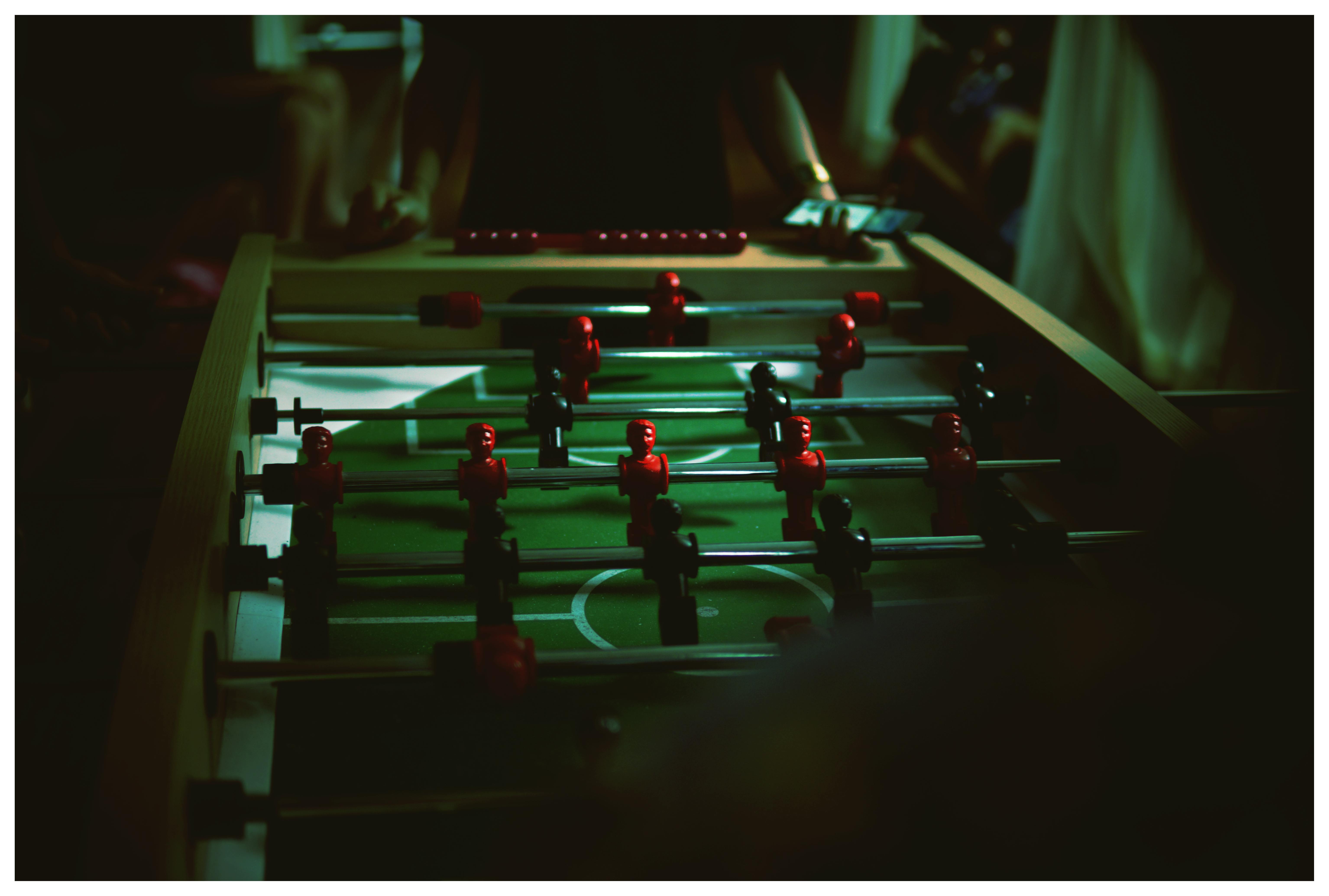 person standing near foosball table