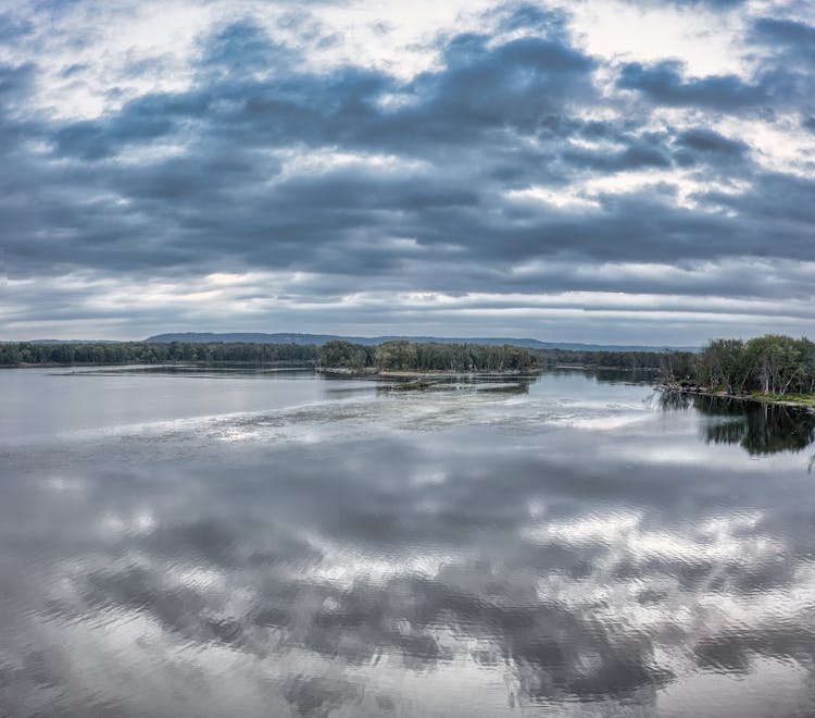 Water Reflection Of Clouds In The Sky