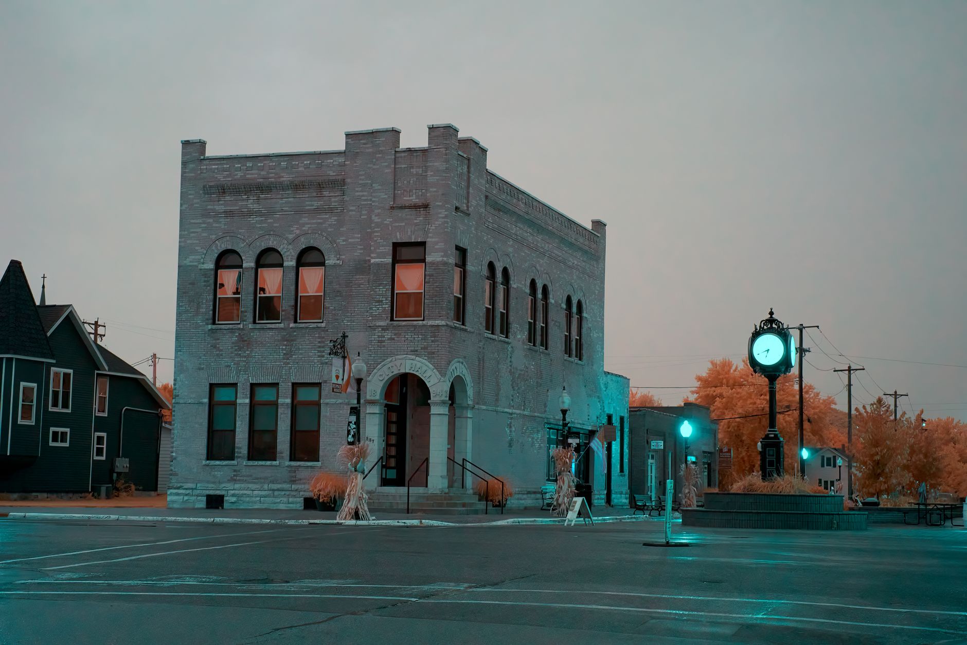 Scenic view of a historic building and street clock in Wabasha, MN during sunset.