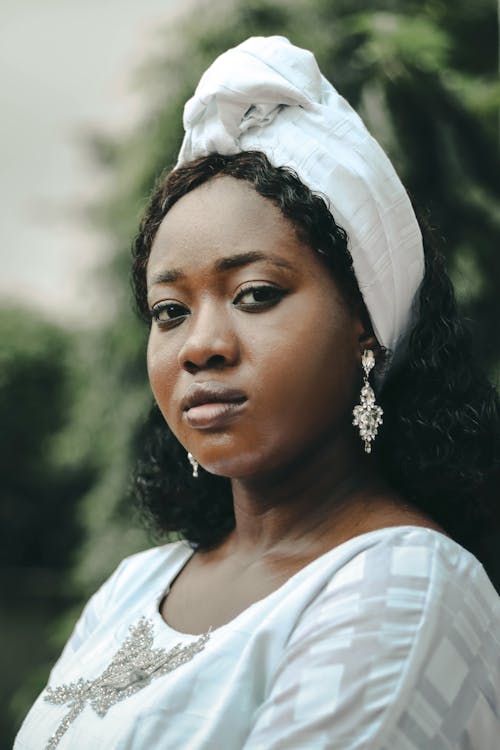 Portrait of a Young Woman in a White Dress