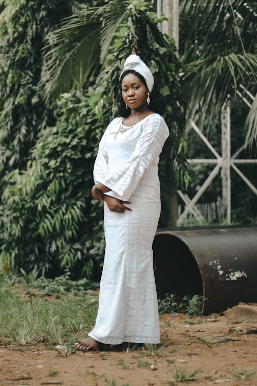 Model with Earrings in White Dress