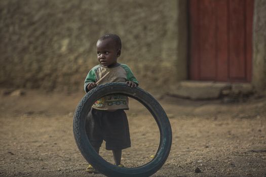 A Boy Holding a Tire