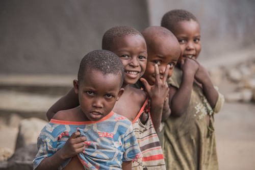 Free Group of African children smiling and posing outdoors, capturing playful childhood moments. Stock Photo