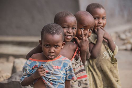 Free A group of happy children playing outdoors, capturing smiles and joy in their natural setting. Stock Photo
