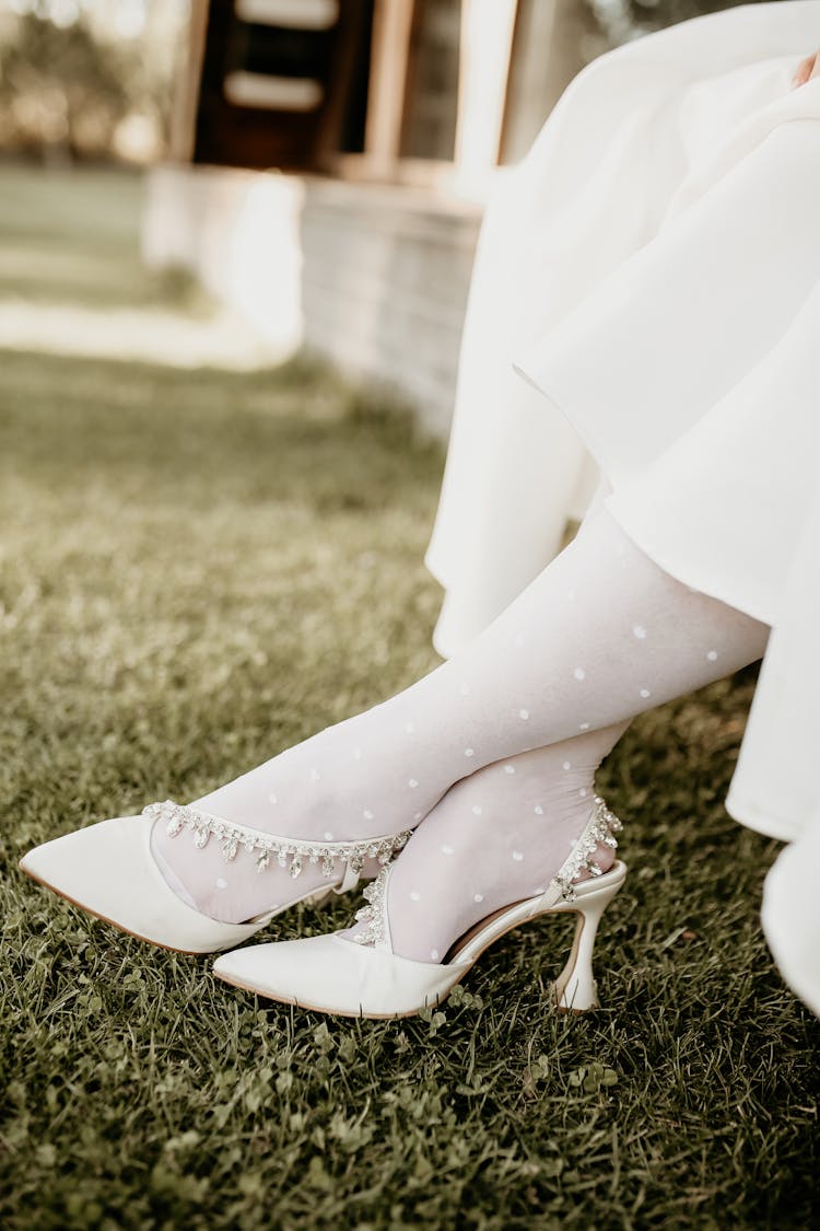 Woman Wearing A White Stockings And Wedding Shoes