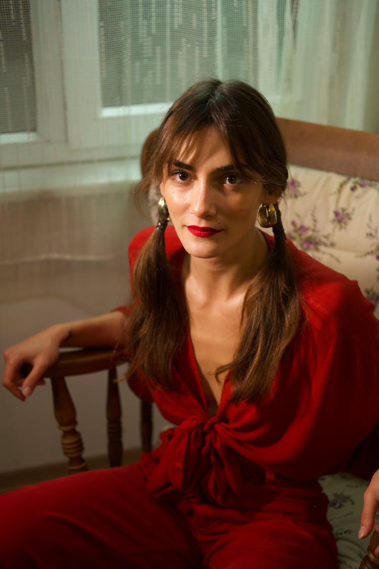 Woman In Pigtails Sitting In A Rocking Chair