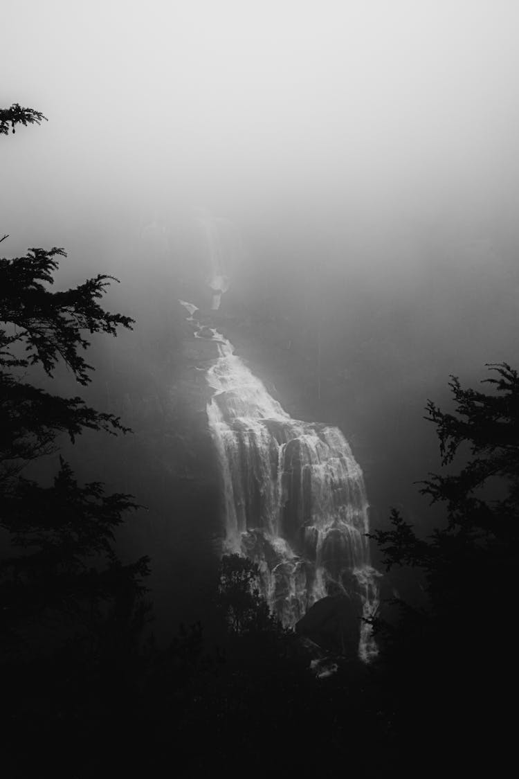 Fog Over Waterfall On Mountain