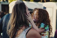 Woman Carrying Girl While Showing Smile