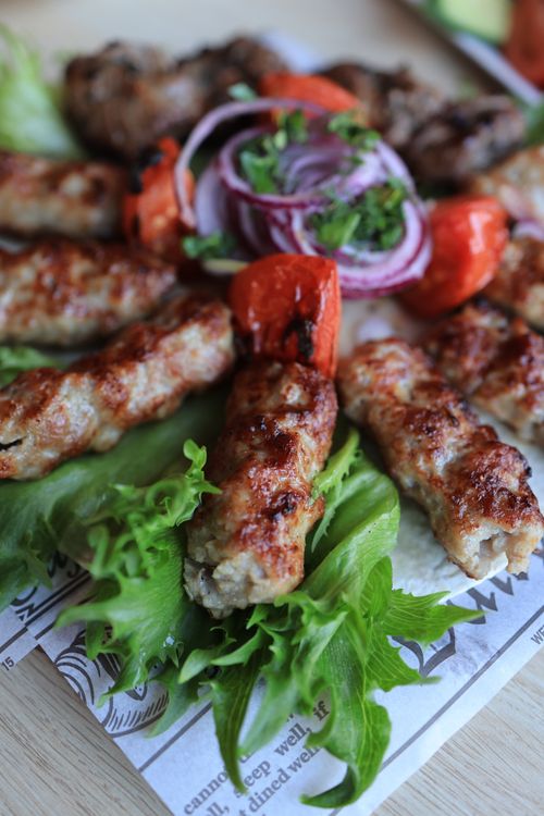 Free Juicy grilled kebabs served with fresh vegetables, herbs, and red onions. Stock Photo