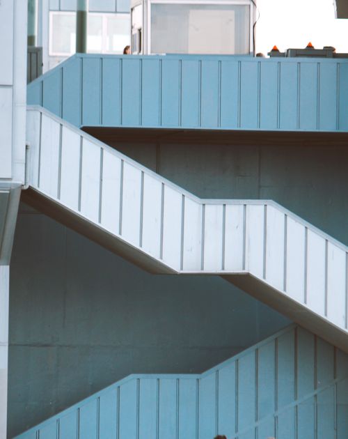 Free Blue and white urban staircase with geometric design on a building exterior. Stock Photo