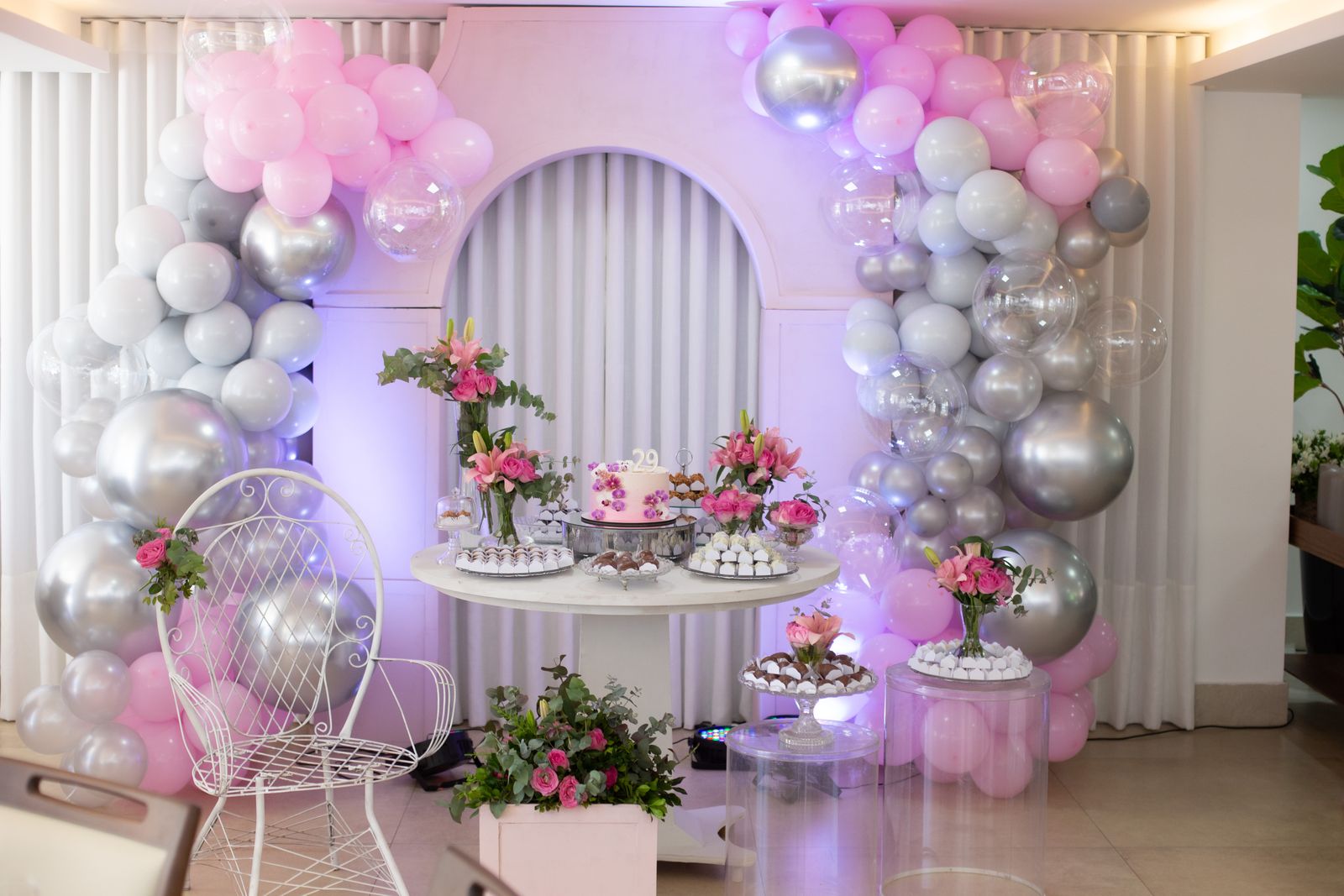 Soft balloon and floral installation above a reception space