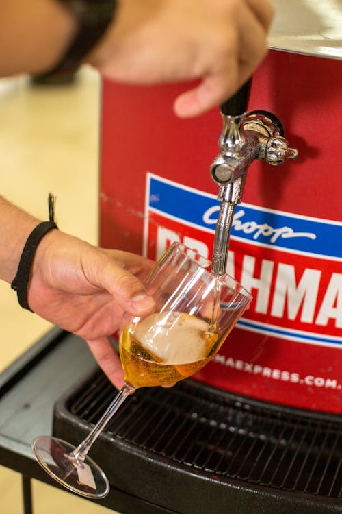 Man Hands Pouring Beer to Glass