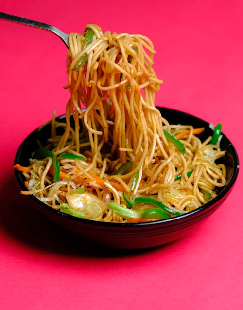 Close-Up Shot of Delicious Instant Noodles on Black Ceramic Plate