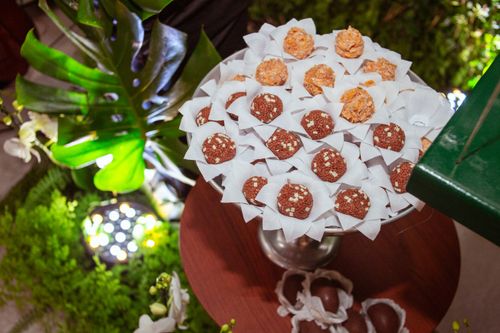 Free Top view of assorted truffles elegantly arranged on decorative table with greenery. Stock Photo