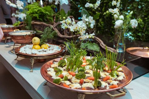 Beautifully presented gourmet dishes garnished with fresh herbs and vegetables, creating a vibrant and inviting display.