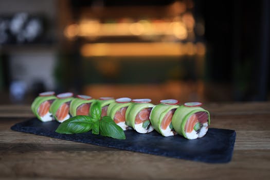 Delicious sushi rolls with salmon and avocado on a slate platter, perfect for food lovers.