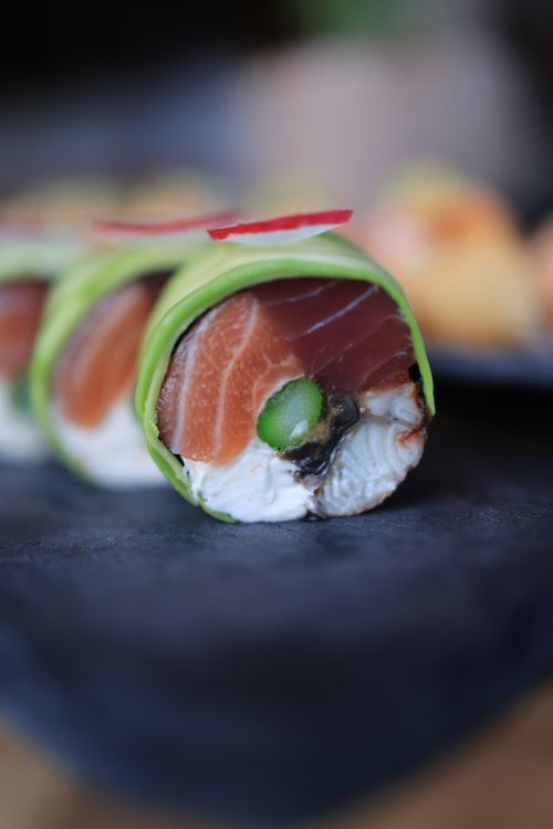 Free Close-up shot of vibrant sushi roll featuring fresh salmon and avocado, perfect for Japanese cuisine lovers. Stock Photo