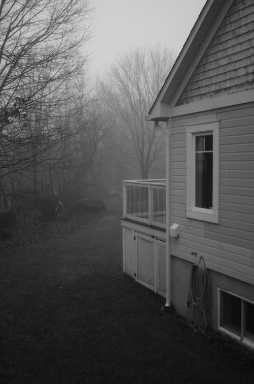 Grayscale Photo of Wooden House 