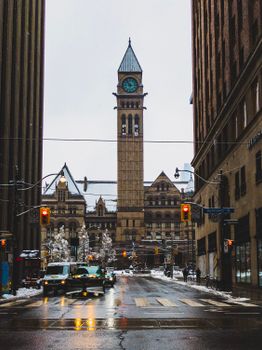 Historic Toronto Old City Hall clock tower during a snowy winter day.