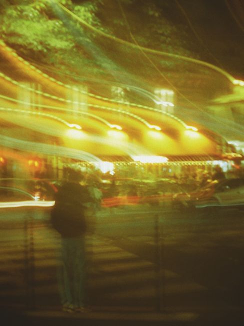 Captivating long exposure shot of a bustling city street with vibrant light trails.
