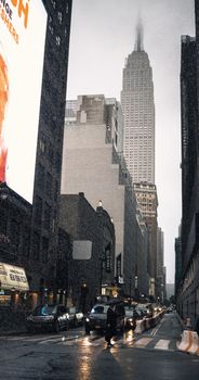 A snowy street in New York City with the Empire State Building in the background, capturing the essence of winter in the city.