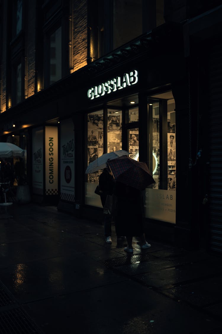 People Under Umbrellas On Night Street 