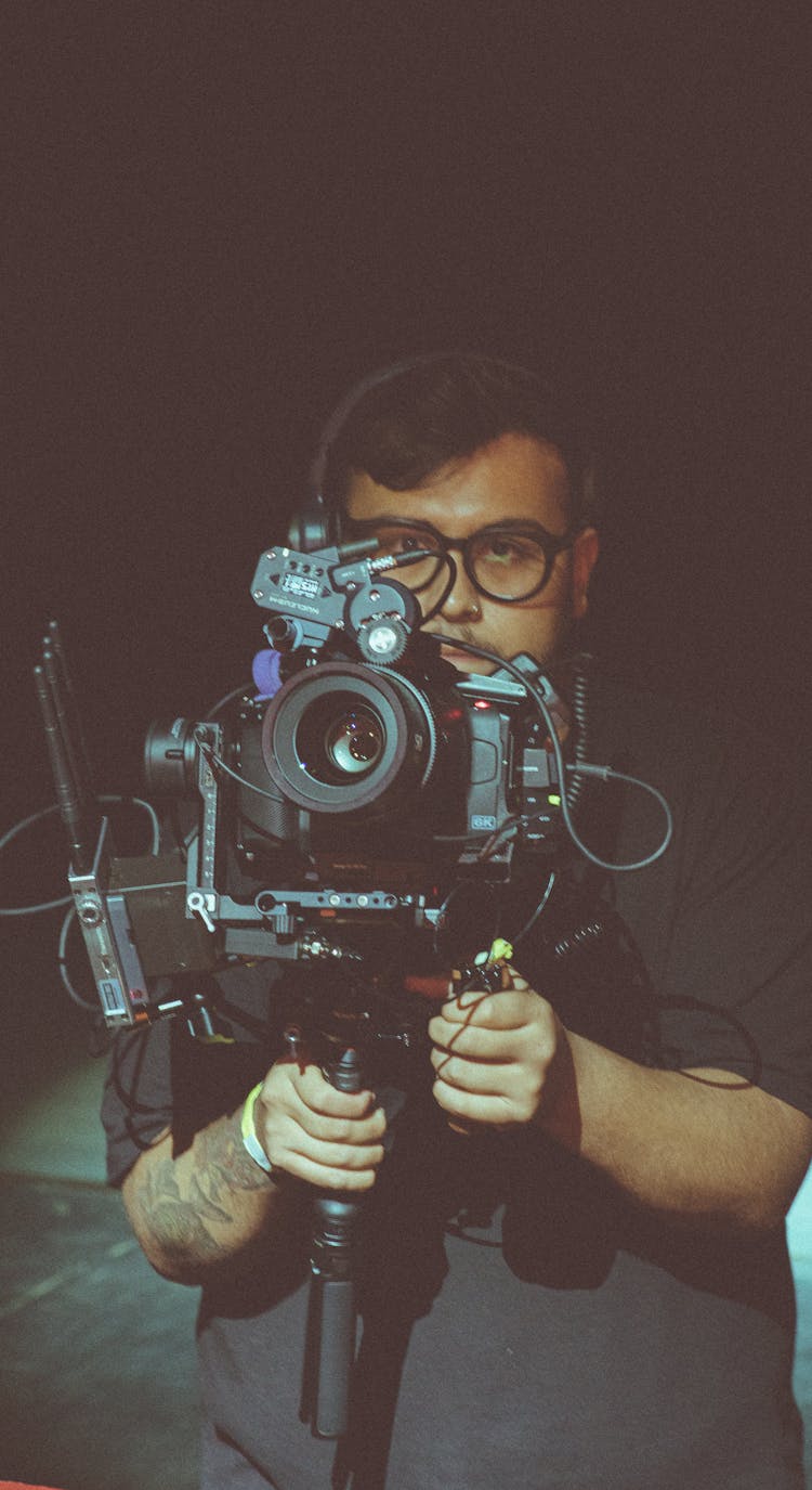 Man Holding A Professional Camera 