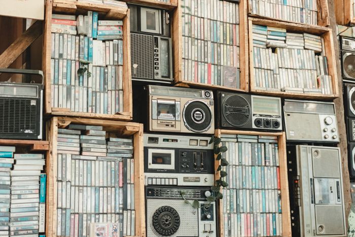 Vintage cassette tapes and radios on a shelf — photo by Erwin Salas on Pexels